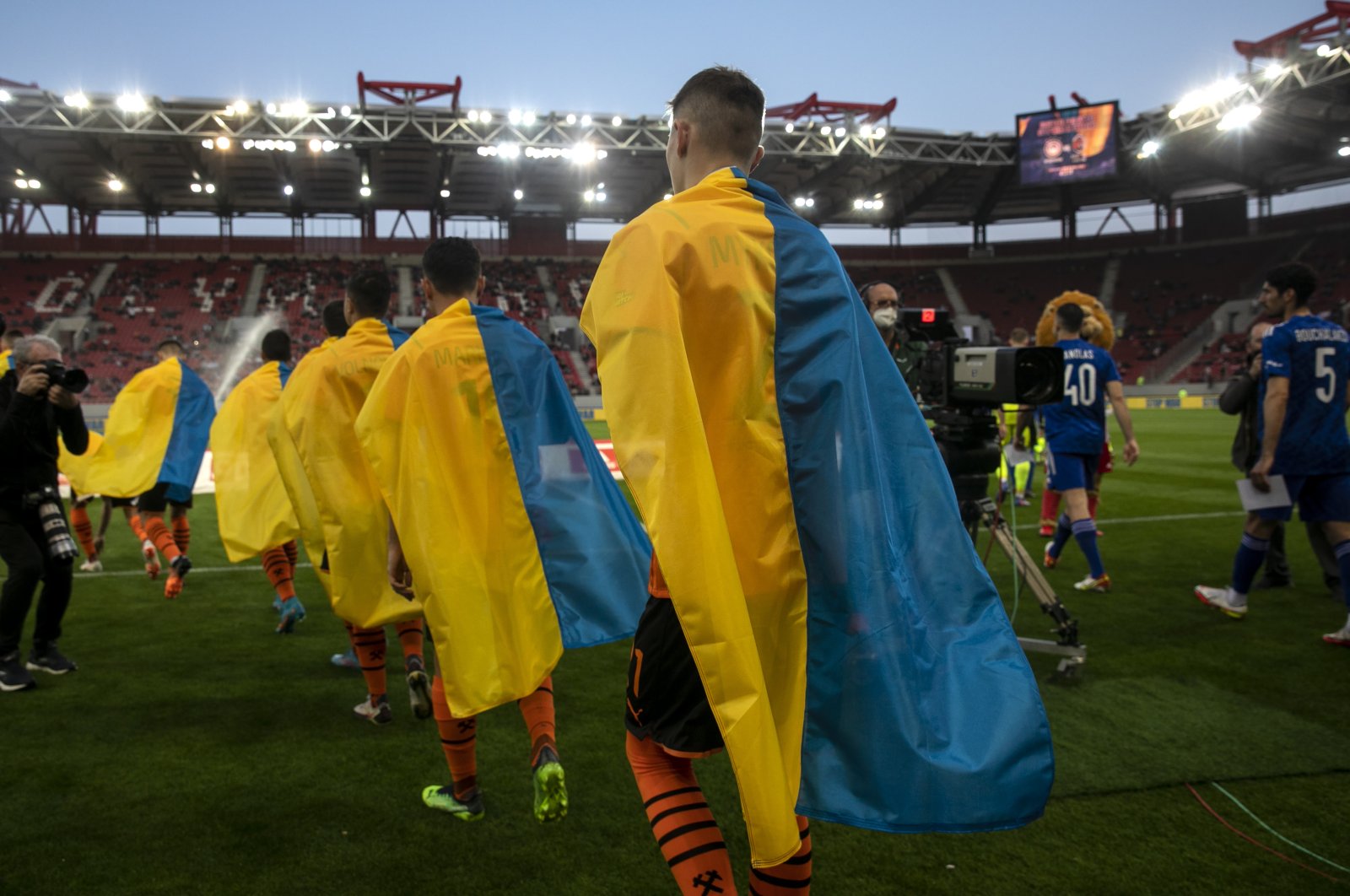 Shakhtar Donetsk players enter the pitch ahead of a friendly match against Olympiakos, Athens, Greece, April 9, 2022. (AP Photo)