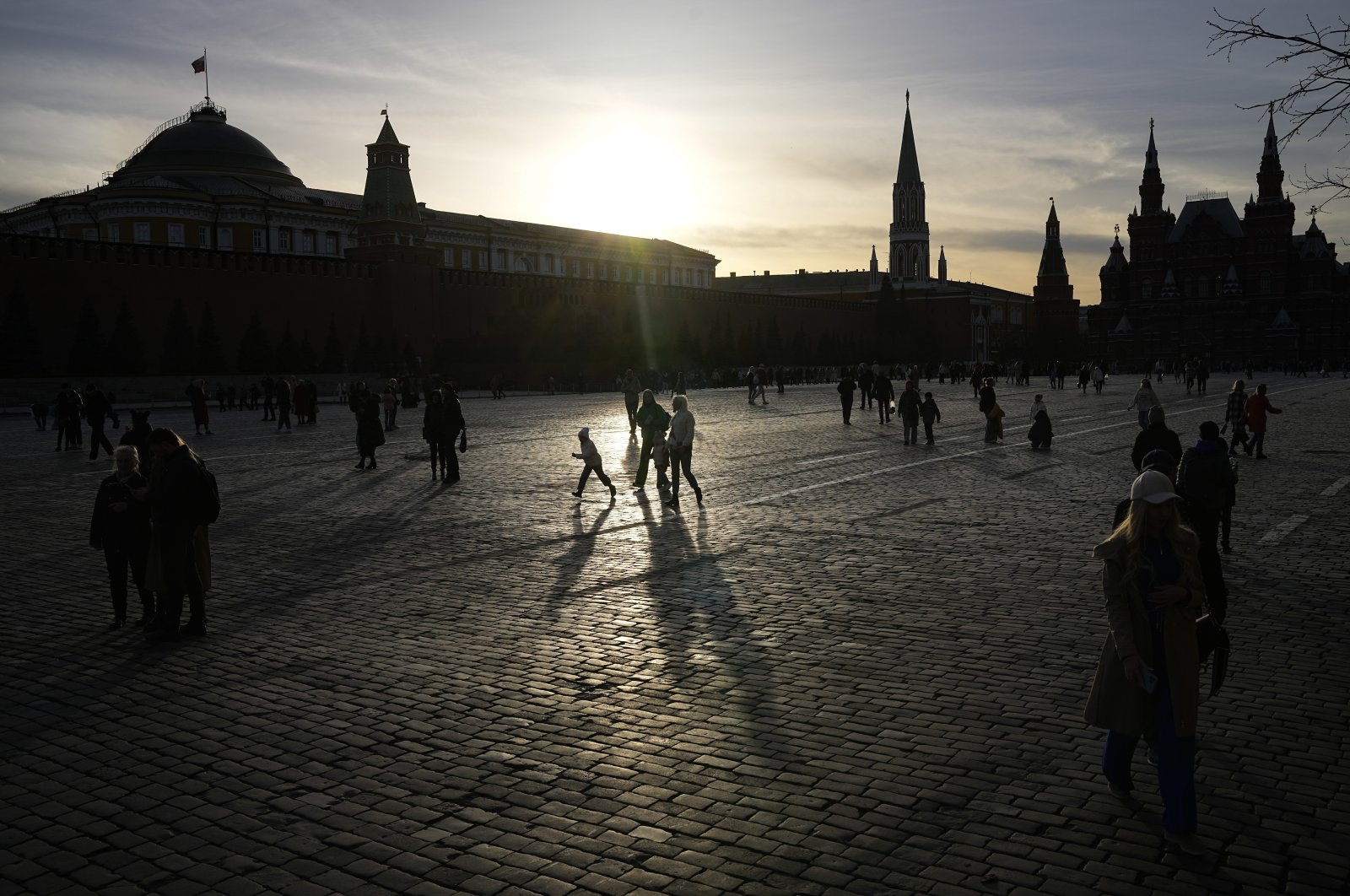 People walk through Red Square during sunset in Moscow, Russia, April 14, 2022. (AP Photo)