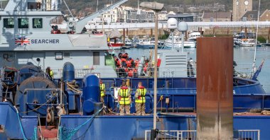 Migrants are escorted by Border Force officers and members of the military after crossing the English Channel in Dover, Britain, April 15, 2022. (EPA Photo)