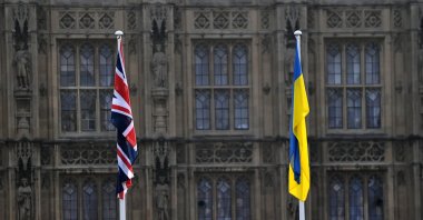 A British and a Ukrainian flag outside parliament in London, Britain, March 3, 2022. (EPA Photo)