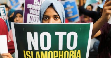 A citizen holds a placard during a peace vigil organized by citizens against what they say is rise in hate crimes and violence against Muslims in the country, in New Delhi, India, April 16, 2022. (Reuters Photo)
