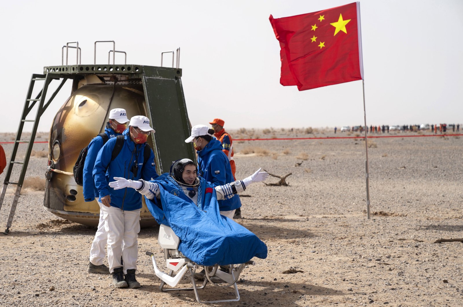 In this photo released by China&#039;s Xinhua News Agency, Chinese astronaut Ye Guangfu sits outside the return capsule of the Shenzhou-13 manned space mission after landing at the Dongfeng landing site in northern China&#039;s Inner Mongolia Autonomous Region, Saturday, April 16, 2022. (Cai Yang/Xinhua via AP)