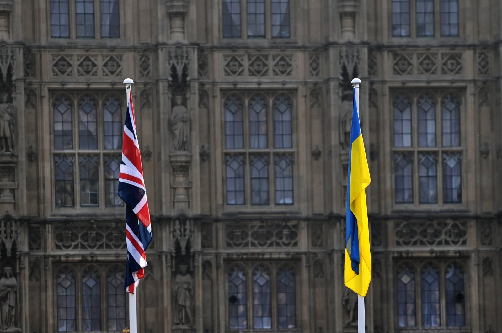 A British and a Ukrainian flag outside parliament in London, Britain, March 3, 2022. (EPA Photo)