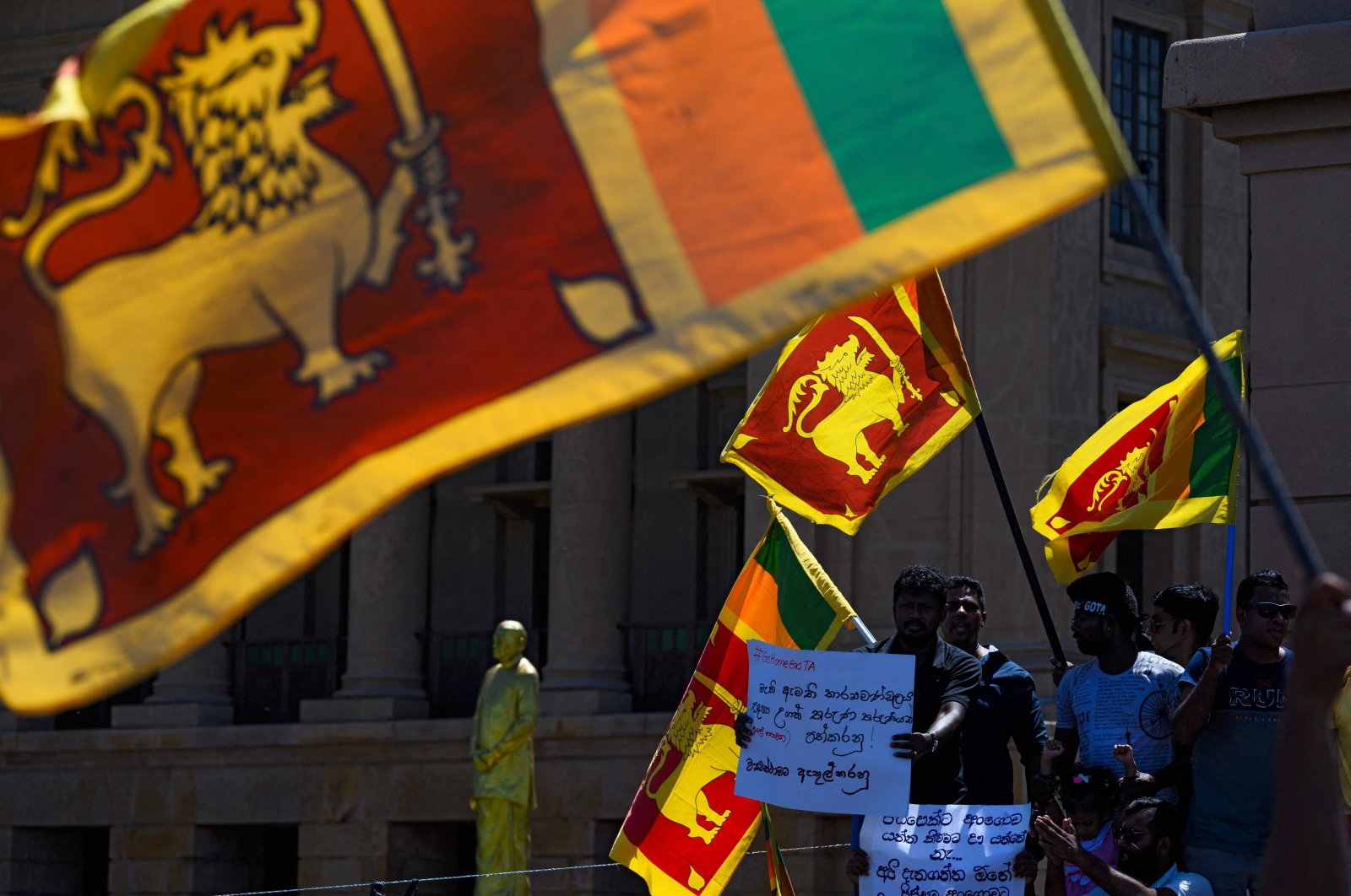 People display placards during an ongoing anti-government demonstration near the president&#039;s office in Colombo, Sri Lanka, April 16, 2022. (AFP Photo)
