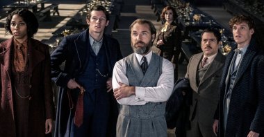From left Jessica Williams, Callum Turner, Jude Law, Fionna Glascott, Dan Fogler and Eddie Redmayne, in a scene from the film &quot;Fantastic Beasts: The Secrets of Dumbledore.&quot; (Warner Bros. Pictures via AP)
