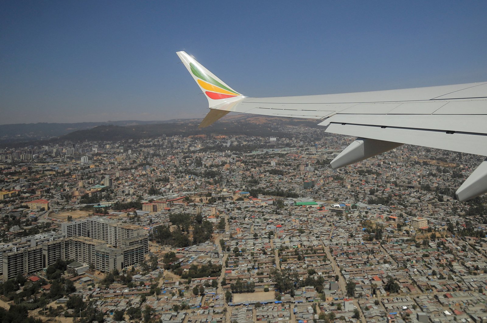The wing of an Ethiopian Airlines Boeing 737 Max 8 plane is seen during a demonstration trip to resume flights over the skies of Addis Ababa, Ethiopia, Feb. 1, 2022. (REUTERS Photo)