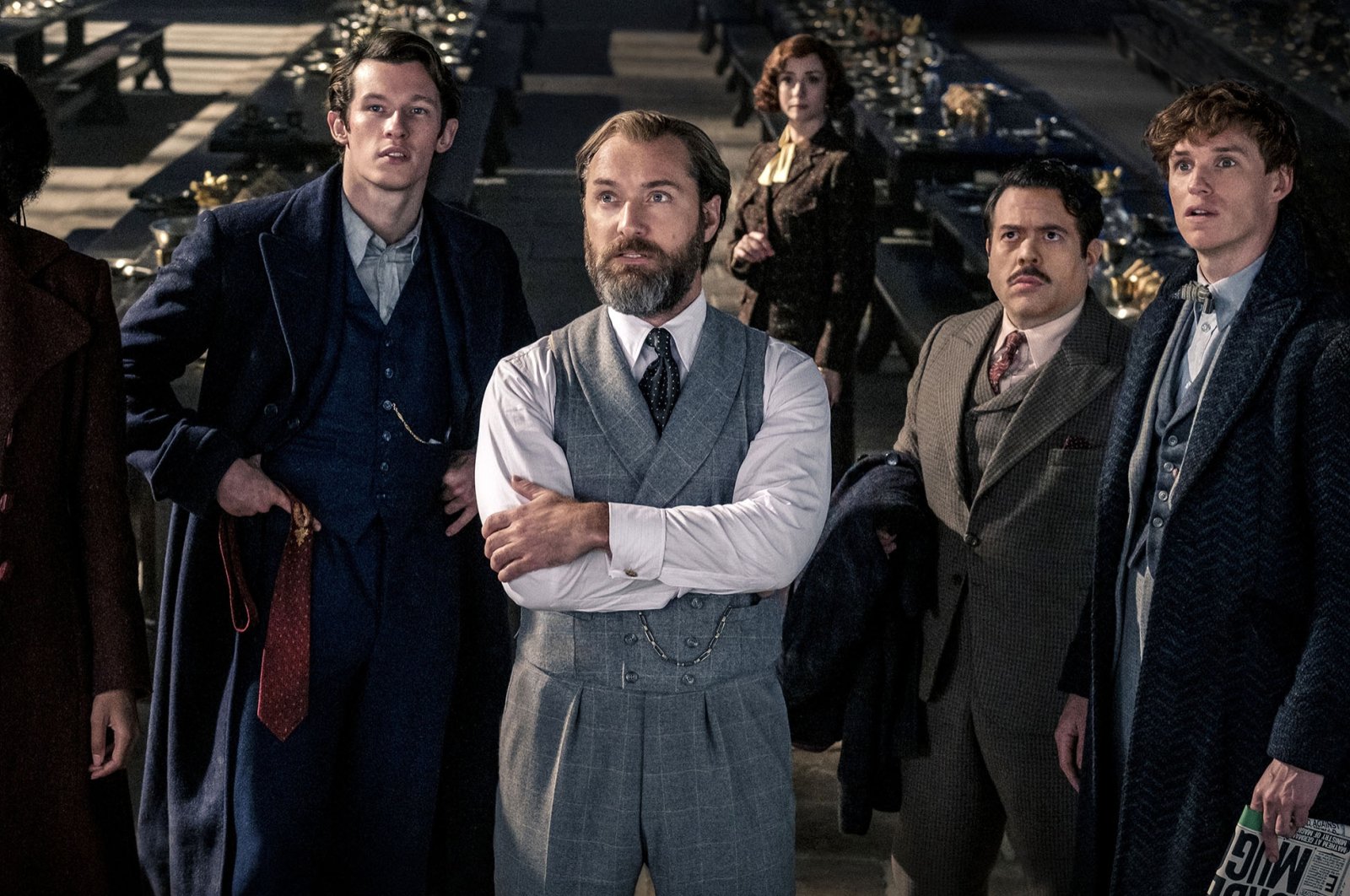 From left Jessica Williams, Callum Turner, Jude Law, Fionna Glascott, Dan Fogler and Eddie Redmayne, in a scene from the film &quot;Fantastic Beasts: The Secrets of Dumbledore.&quot; (Warner Bros. Pictures via AP)