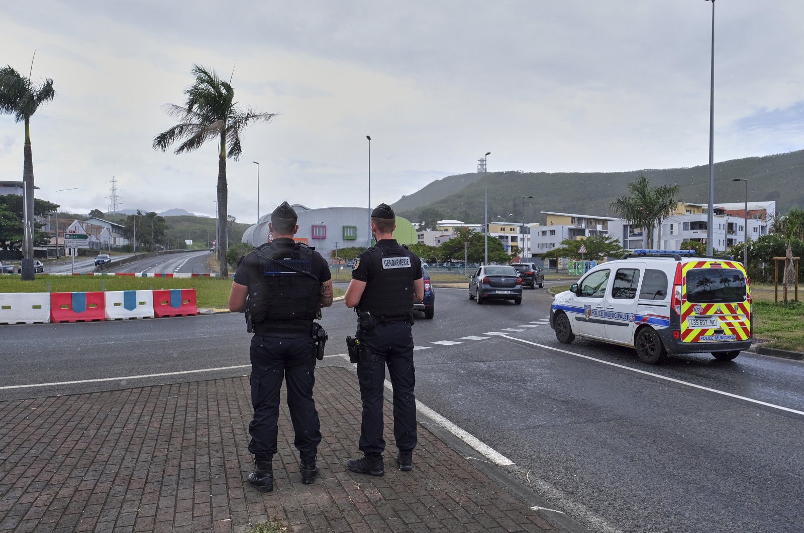 French gendarme patrol at a roundabout in Noumea, New Caledonia, Sunday, Dec.12, 2021. (AP File Photo)