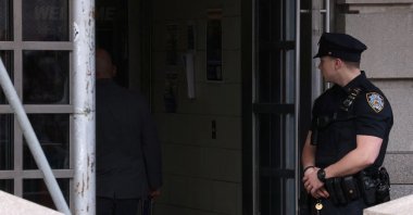 A New York City Police Department (NYPD) officer stands outside the precinct where the suspect in the Brooklyn subway shooting is being held in Manhattan, New York City, U.S., April 13, 2022. (REUTERS Photo)
