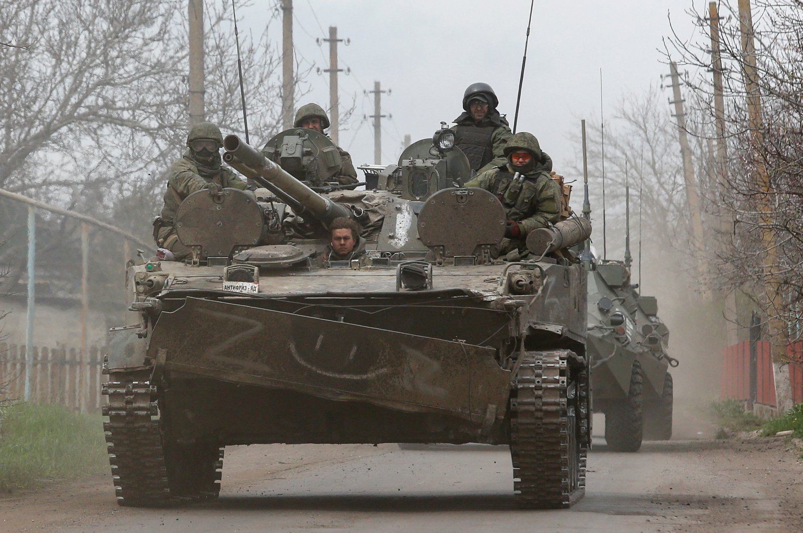 Russian forces sit atop of an armored vehicle during the Russian invasion, in Mariupol, Ukraine, April 17, 2022. (Reuters Photo)