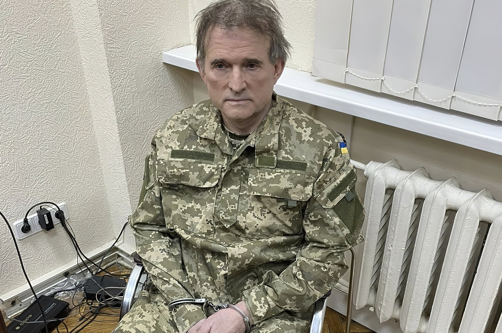 Oligarch Viktor Medvedchuk, who is both the former leader of a pro-Russian opposition party and a close associate of Russian leader Vladimir Putin, sits handcuffed after being detained in a special operation carried out by the country&#039;s SBU secret service, Ukraine, April 12, 2022. (AP Photo)