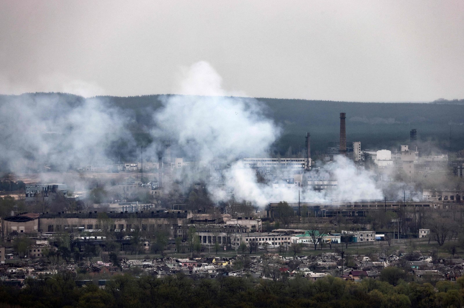 A photograph taken from Novodruzhesk village shows smoke rising in Rubizhne city on the 54th day of the Russian invasion of Ukraine, April 18, 2022. (AFP Photo)