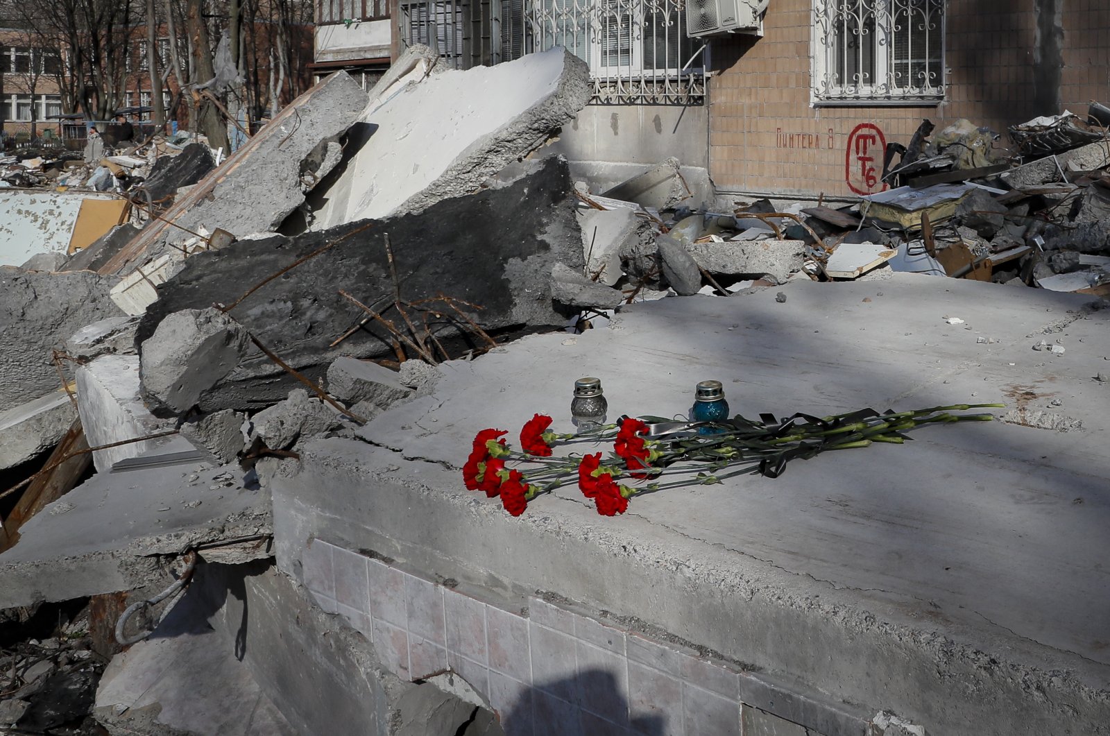 Flowers are placed on the rubble of destroyed apartment buildings in the shelling two weeks ago by a Uragan missile, in Donetsk, Ukraine, April 11, 2022. (EPA Photo)