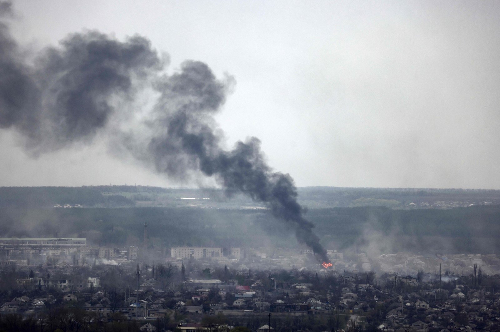 A photograph taken from Novodruzhesk village, shows dark smoke rising in Rubizhne city, April 18, 2022, on the 54th day of the Russian invasion of Ukraine. (AFP Photo)