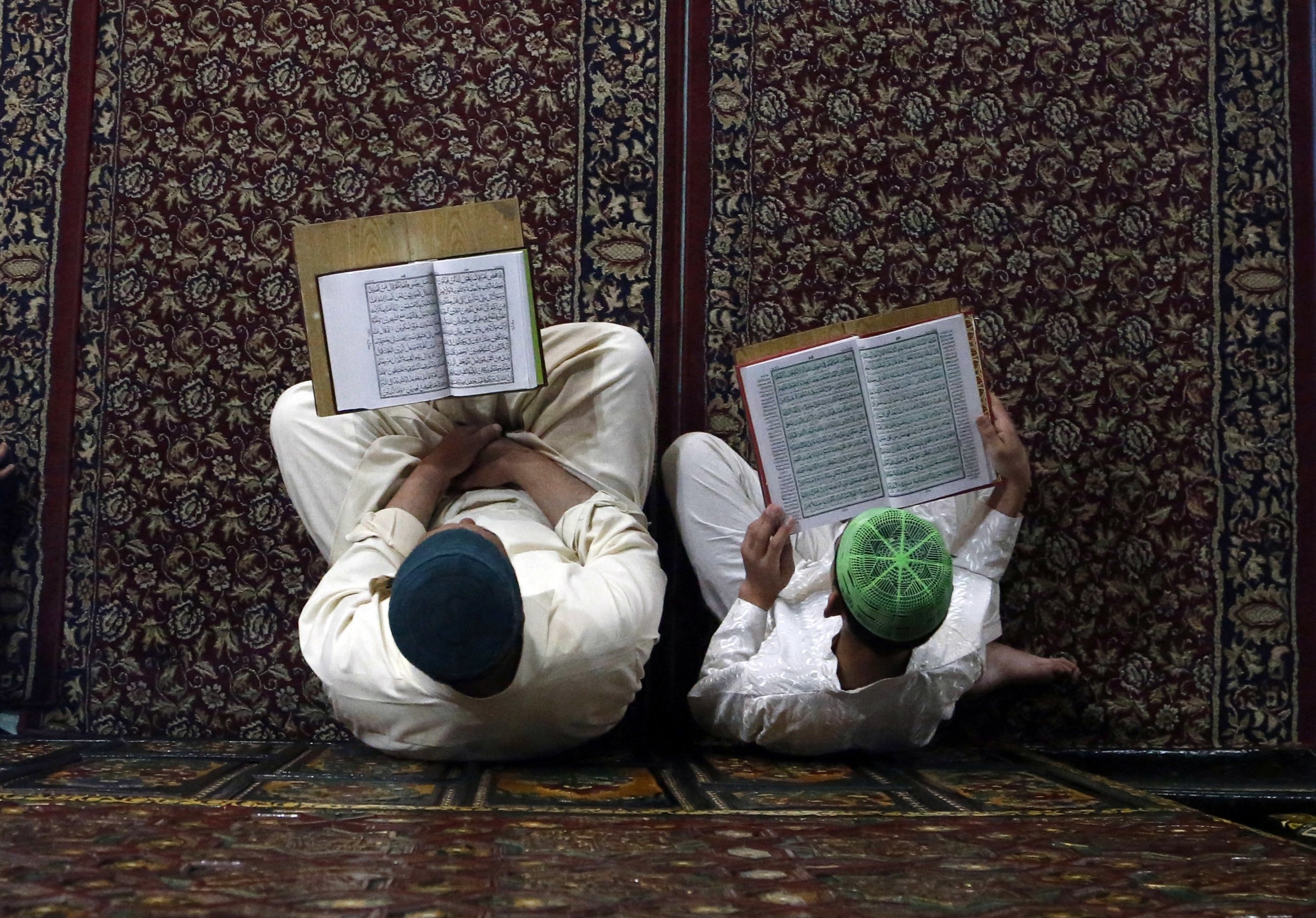 Kashmiri Muslims read verses from the Quran, Islam's holy book, inside the shrine of Shah-e-Hamdan during the holy month of Ramadan in Srinagar, Kashmir, May 29, 2017. (AP)