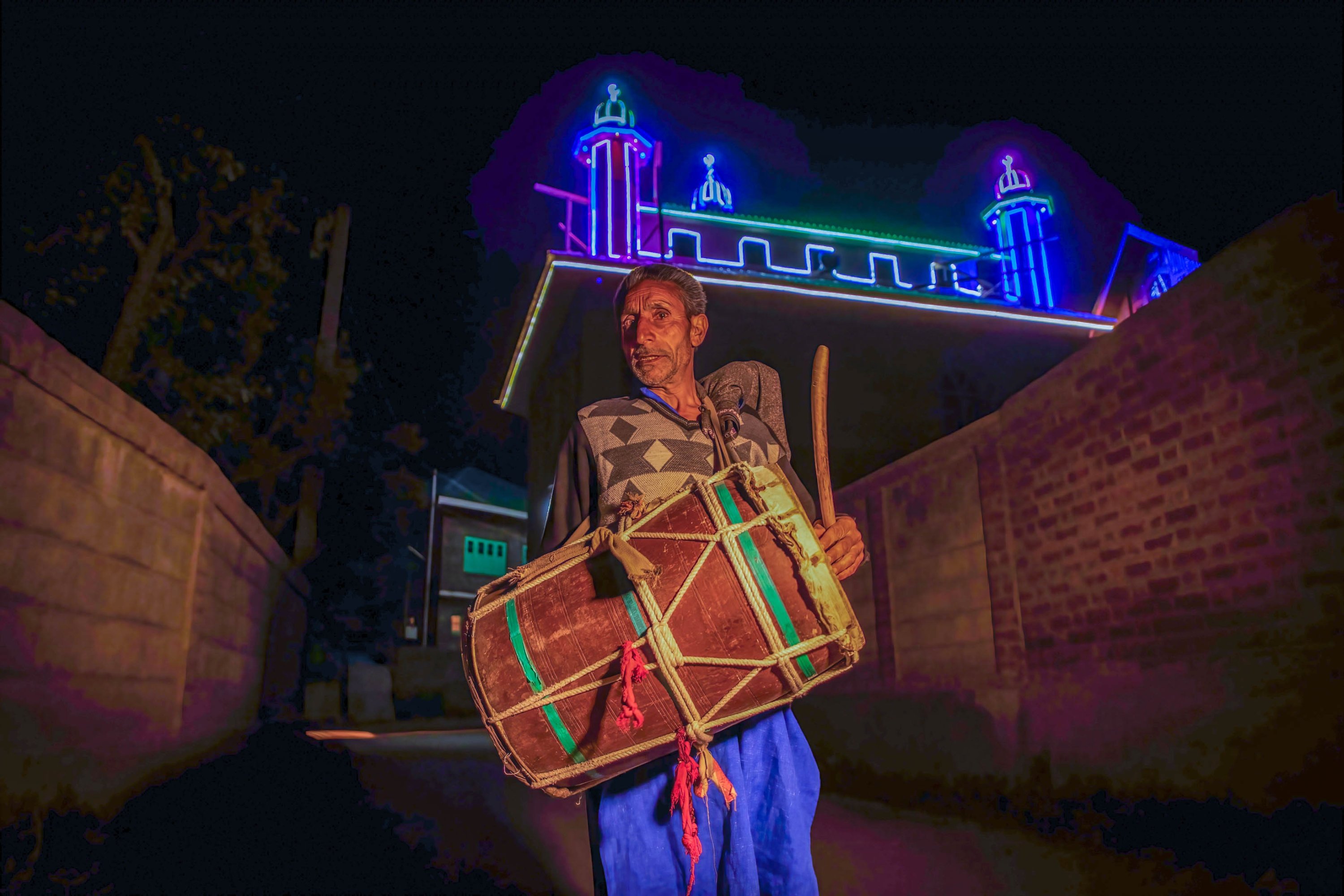 Ali Mohammad, 55, a Kashmiri Ramadan drummer or human alarm, bangs his drum as he walks through the dark alleys in the outskirts of Srinagar, Kashmir on Apr. 10, 2022, alerting Muslim residents to wake up for pre-dawn meals before the start of the following day’s fast during the holy month of Ramadan. (REUTERS)