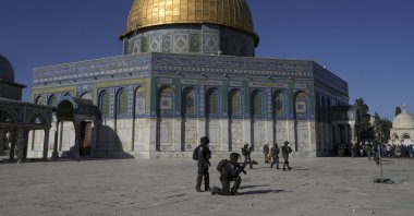 Israeli security forces take position against Palestinian worshipers in front of the Dome of the Rock shrine in their raid of the Al-Aqsa Mosque, East Jerusalem, occupied Palestine, April 15, 2022. (AP Photo)