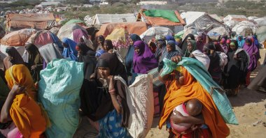 Somalis who fled drought-stricken areas carry their belongings as they arrive at a makeshift camp on the outskirts of the capital Mogadishu, Somalia, Feb. 4, 2022. (AP Photo)