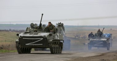 Russian military vehicles move on a highway in an area controlled by Russian-backed separatist forces near Mariupol, Ukraine, April 18, 2022. (AP Photo)