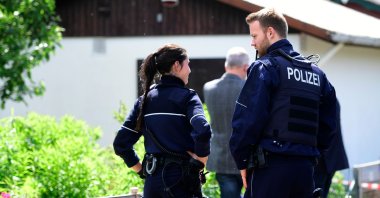 Police officers stand in front of a summer house, where sexual abuse of children, aged 5, 10 and 12 years old, are suspected to have taken place in Muenster, western Germany, June 6, 2020. (AFP Photo)