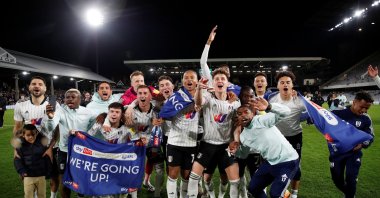 Fulham players celebrate after being promoted to the Premier League after a football match between Fulham and Preston North End at Craven Cottage, London, Britain, April 19, 2022. (Reuters Photo) 