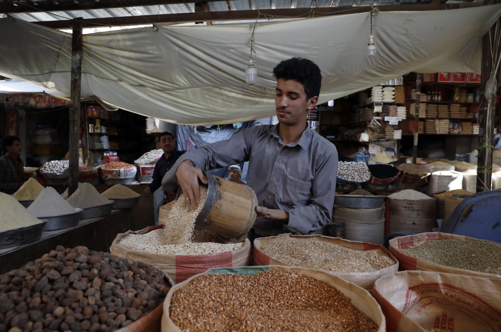 A Yemeni vendor displays types of imported grains for sale amid a food price spike at a market in the old city of Sanaa, Yemen, April 10, 2022. (EPA Photo)