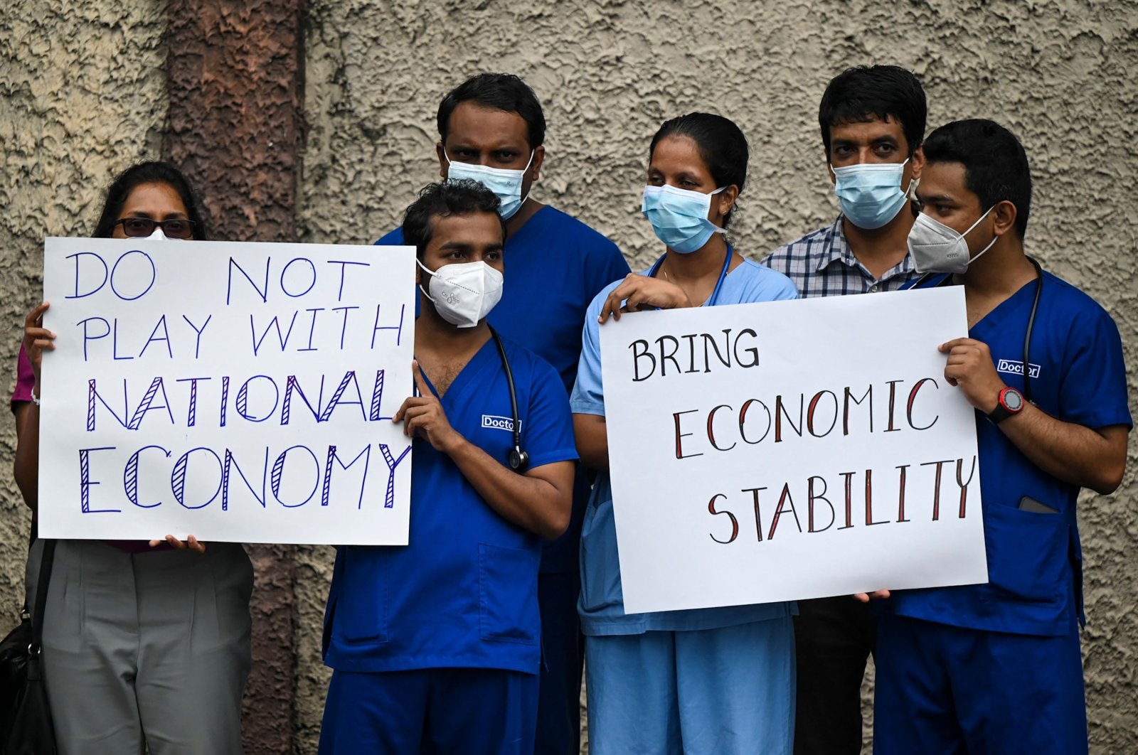 Doctors and nurses of the Lady Ridgeway Children&#039;s hospital hold placards during a silent demonstration against shortages of medicines in Colombo, Sri Lanka, April 19, 2022. (AFP Photo)
