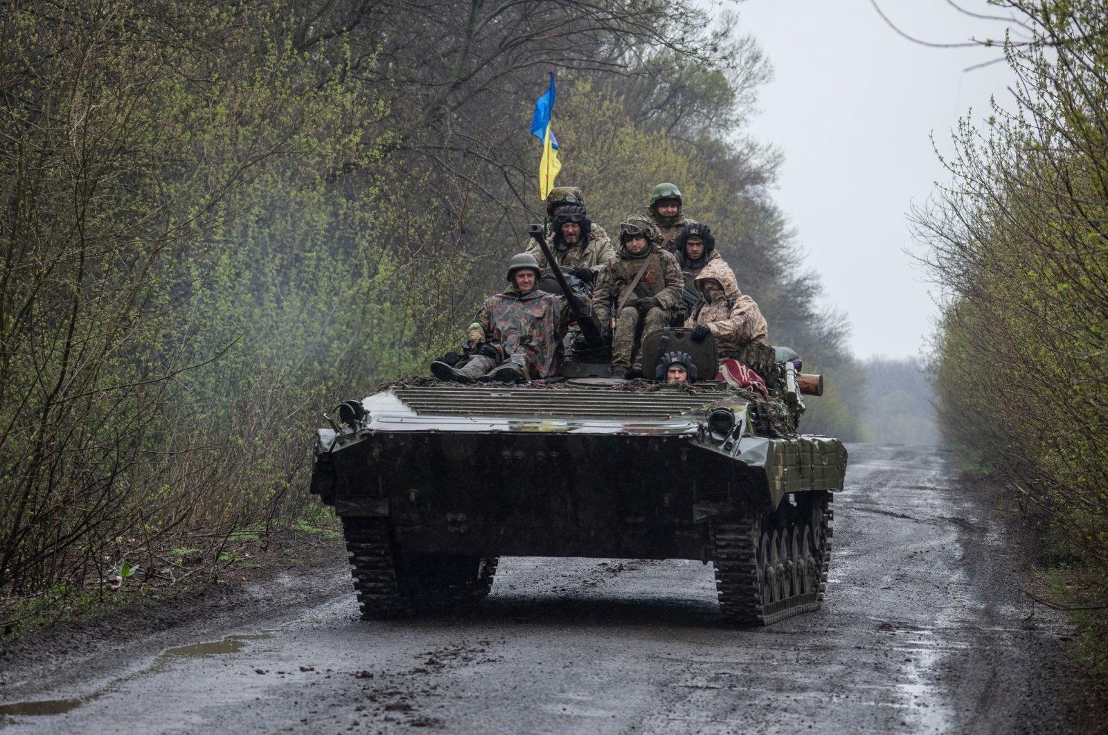 Ukrainian servicemen ride atop an armored fighting vehicle, as Russia&#039;s attack on Ukraine continues, at an unknown location in eastern Ukraine, in this handout picture released April 19, 2022.  (Press service of the Ukrainian Ground Forces/Handout via Reuters)