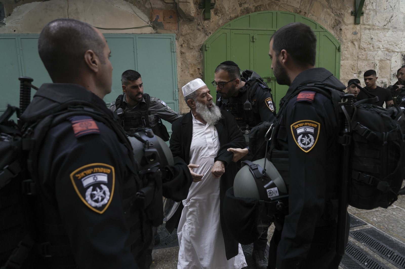 Israel police argue with a Palestinian worshiper in the Old City, East Jerusalem, occupied Palestine, April 17, 2022. (AP Photo)
