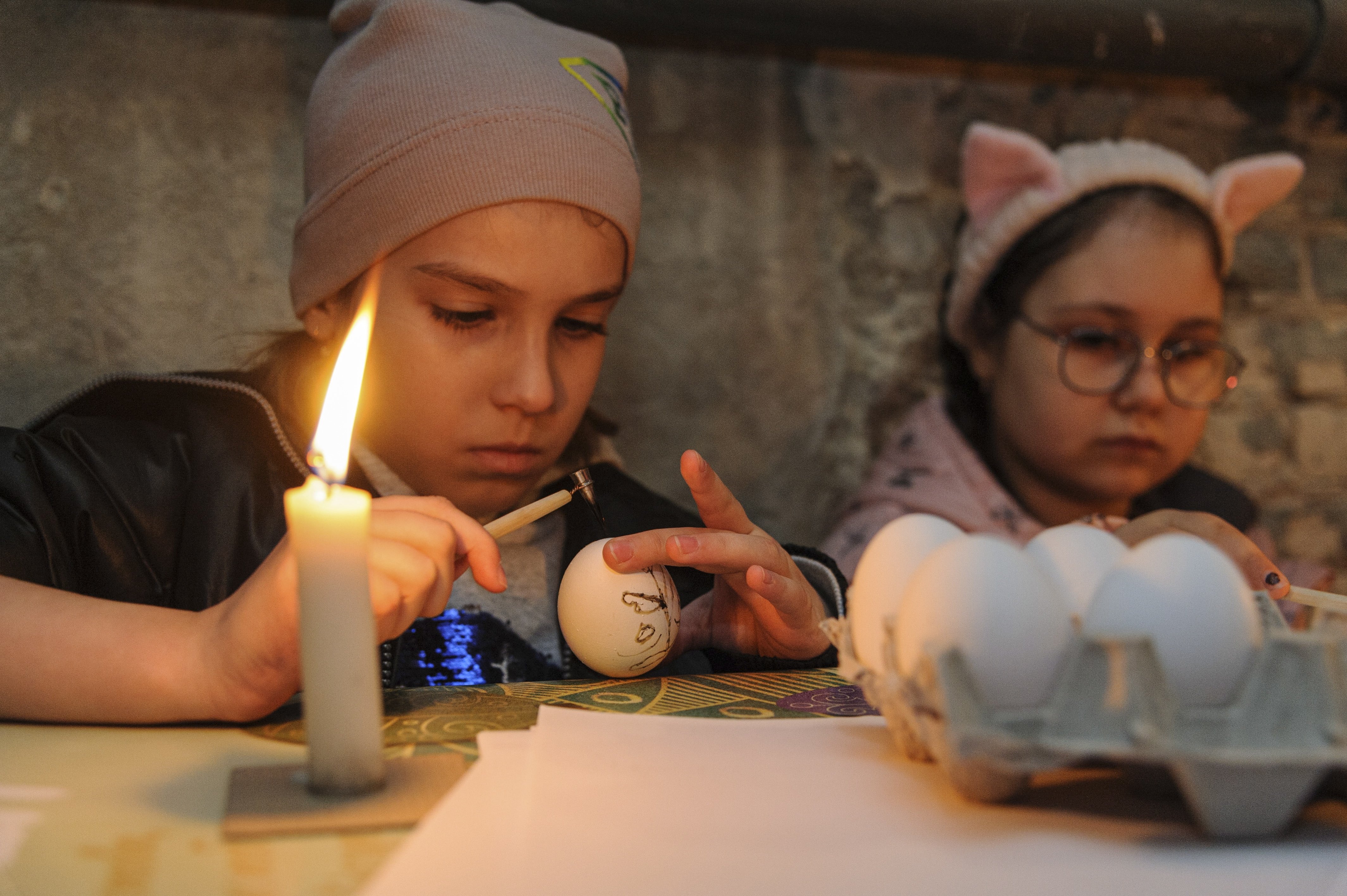Locals and refugees from Eastern Ukraine attend a masterclass titled "Easter painting in a bomb shelter" in order to preserve Ukrainian folk traditions in Lviv, Ukraine, April 19, 2022. (EPA Photo)
