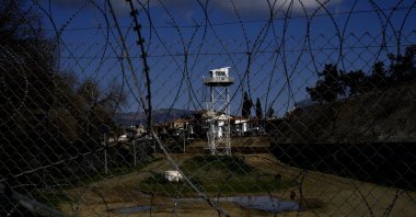 A U.N. tower guard post is seen behind barbed wires inside the U.N.-controlled buffer zone between the Greek Cypriot administration and the Turkish Republic of Northern Cyprus in the divided capital Nicosia, Cyprus, Thursday, Feb. 10, 2022. (AP File Photo)