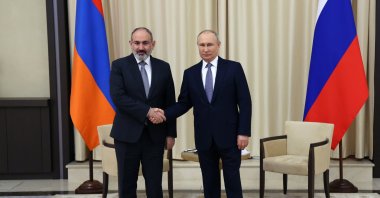 Russian President Vladimir Putin, right, and Armenian Prime Minister Nikol Pashinian shake hands during a meeting at the Novo-Ogaryovo residence outside Moscow, Russia, Tuesday, April 19, 2022. (Vyacheslav Prokofyev, Sputnik, Kremlin Pool Photo via AP)