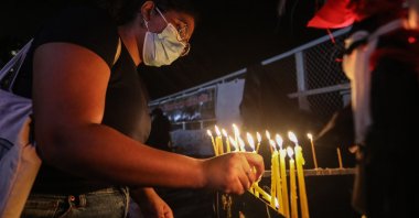 Protesters light candles in memory of the protester killed in a police shooting during the clash in Rambukkana, Colombo, Sri Lanka, April 19, 2022. (EPA Photo)