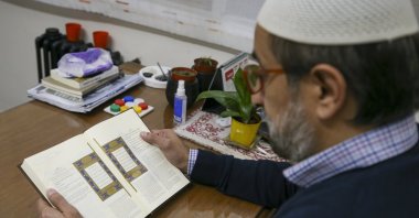 Abel Abduljalel Buzarquis reads the Quran in his office, Buenos Aires, Argentina, April 19, 2022. (AA Photo)