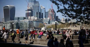 People relax near the bank of the River Thames during sunny weather in central London, Britain, April 16, 2022. (Reuters Photo)