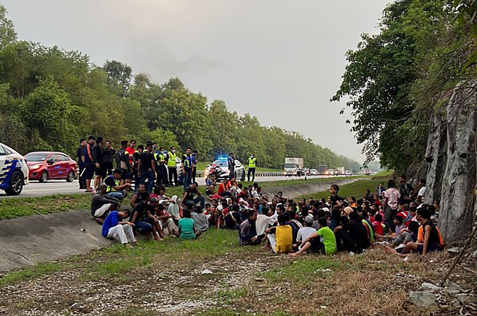 Police detain Rohingya refugees who had escaped from the Sungai Bakap Temporary Immigration Depot, Penang, Malaysia, April 20, 2022. (AP Photo)