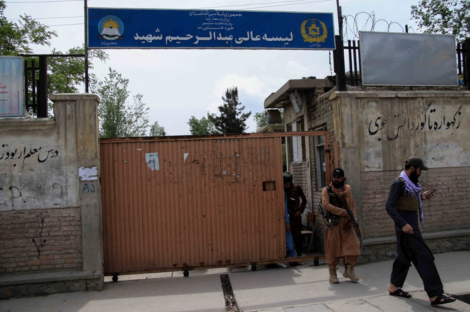 Taliban stand guard outside a school in the aftermath of multiple bomb blasts in a Shiite majority neighborhood, in Kabul, Afghanistan, April 19, 2022. (EPA Photo)