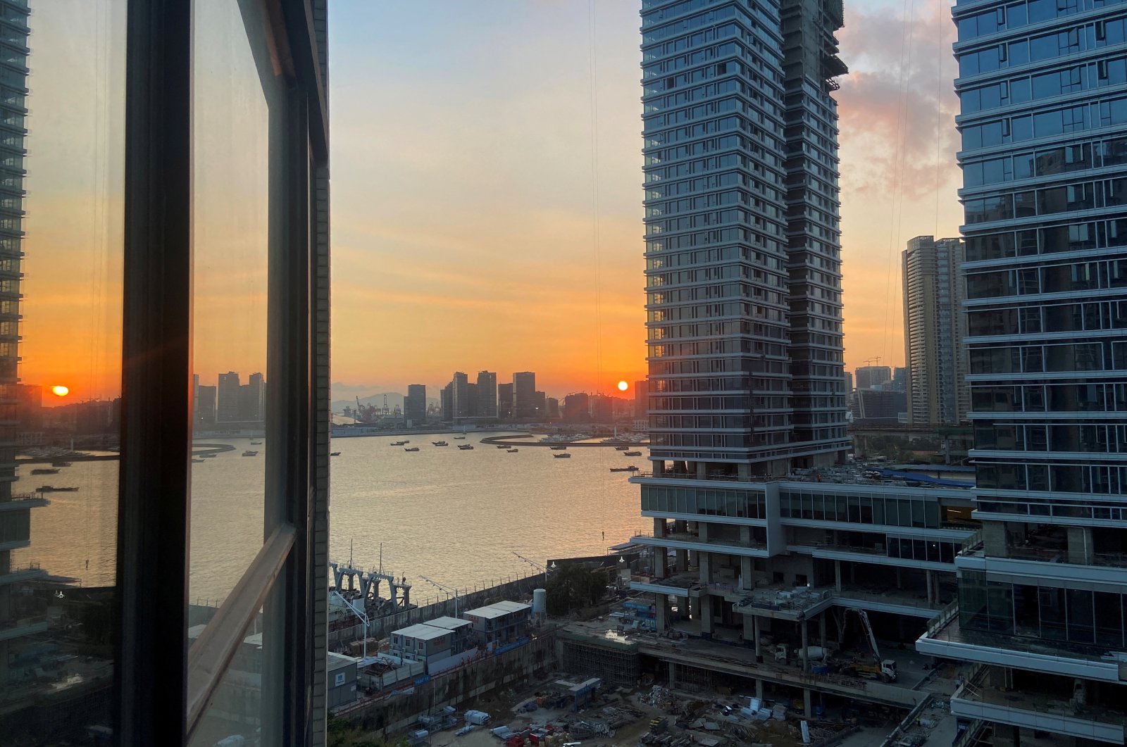 Under-construction apartments are pictured from a building during sunset in the Shekou area of Shenzhen, Guangdong province, China, Nov. 7, 2021. (Reuters Photo)