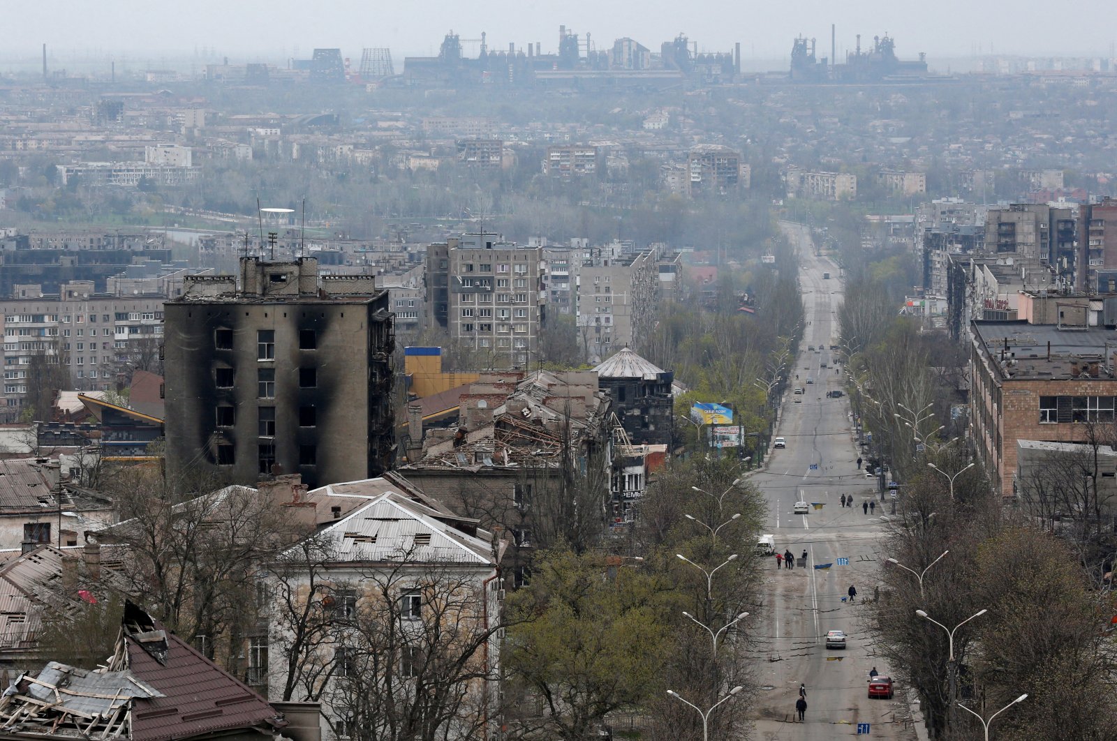 FILE PHOTO: A view shows damaged buildings, with the Azovstal Iron and Steel Works plant in the background, in the southern port city of Mariupol, Ukraine April 19, 2022. REUTERS/Alexander Ermochenko/File Photo