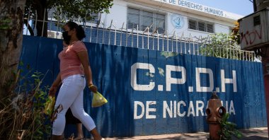 A woman walks past the office of Nicaragua's Permanent Commission on Human Rights (CPDH), closed after the country's parliament, controlled by allies of President Daniel Ortega, shut down 25 nongovernmental organizations (NGOs) that have been critical of the government, in Managua, Nicaragua, April 20, 2022. (Reuters Photo)
