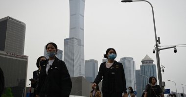 People commute at the central business district in Beijing, China, April 21, 2022. (AFP Photo)