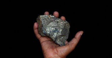 A mine employee shows a piece of copper ore at the Kilembe mines, in the foothills of the Rwenzori Mountains, Uganda, Jan. 31, 2013. (Reuters Photo)