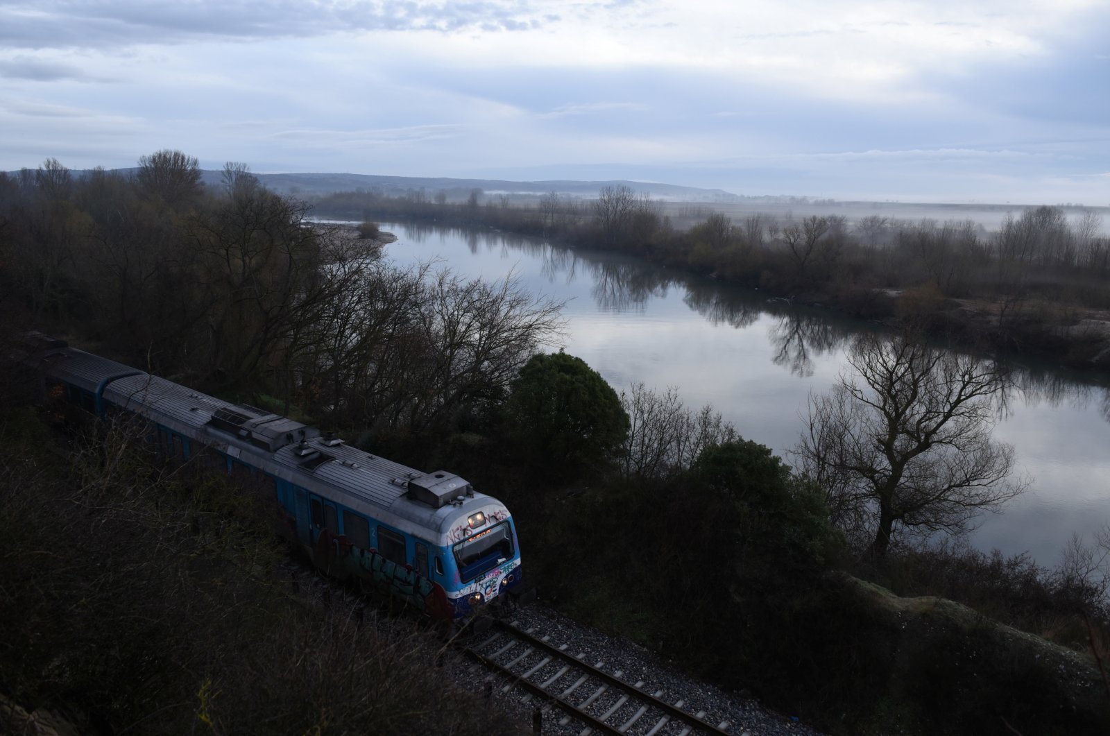 A train passes next to the Evros river, the natural border between Greece and Turkey, near the city of Didymoteicho, in the region of Evros, Greece, March 5, 2020. (Reuters File Photo)