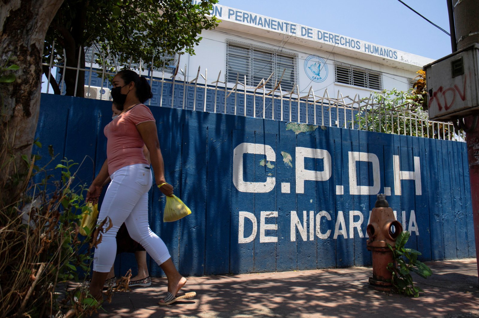 A woman walks past the office of Nicaragua&#039;s Permanent Commission on Human Rights (CPDH), closed after the country&#039;s parliament, controlled by allies of President Daniel Ortega, shut down 25 nongovernmental organizations (NGOs) that have been critical of the government, in Managua, Nicaragua, April 20, 2022. (Reuters Photo)