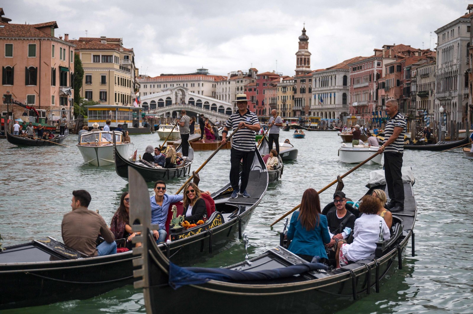 Tourists enjoy a gondola ride on the Grand Canal by the Rialto bridge in Venice, Italy, Sept. 18, 2021. (AFP Photo)