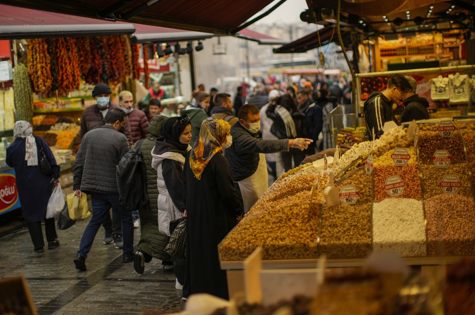 A seller talks to clients at the Egyptian bazaar in Istanbul, Turkey, April, 2022. (AP Photo)