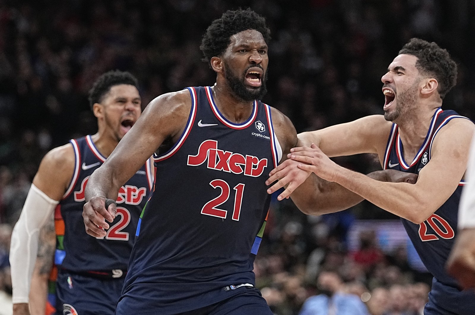 Sixers Georges Niang (R) congratulates teammate Joel Embiid (C) on his game-winning basket against the Raptors in an NBA playoffs game, Toronto, Ontario, Canada, April 20, 2022.