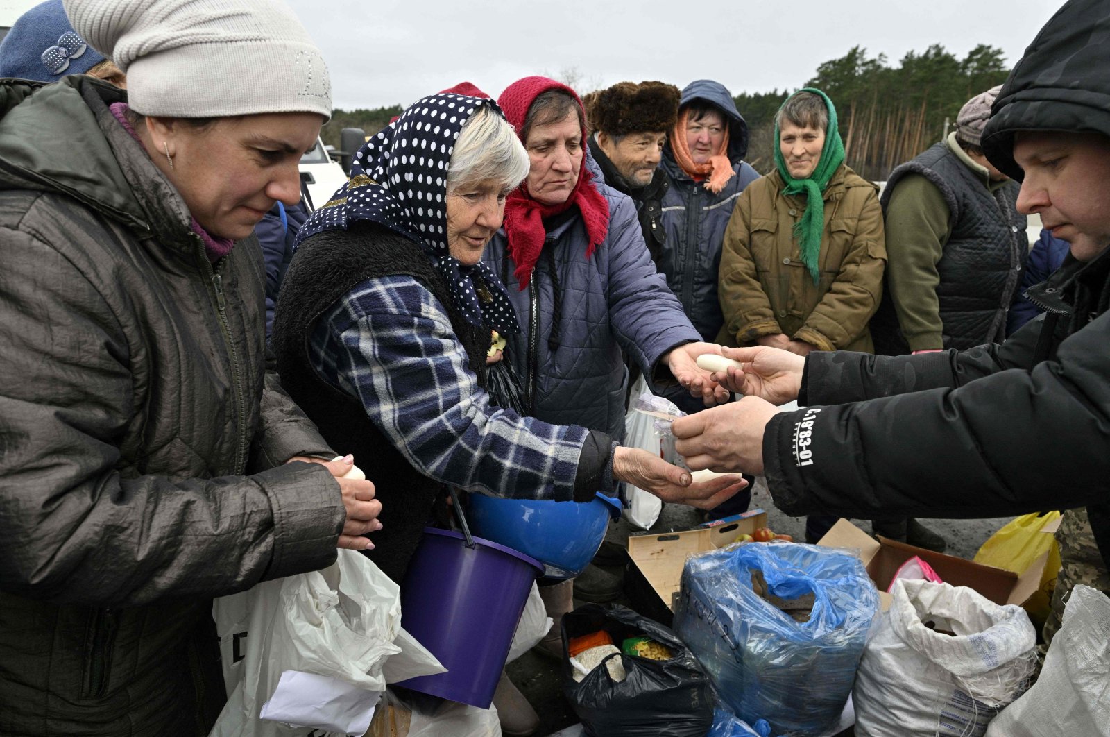 Volunteers distribute food to local residents in the village of Zalissya, northeast of Kyiv, Ukraine, April 19, 2022. (AFP Photo)