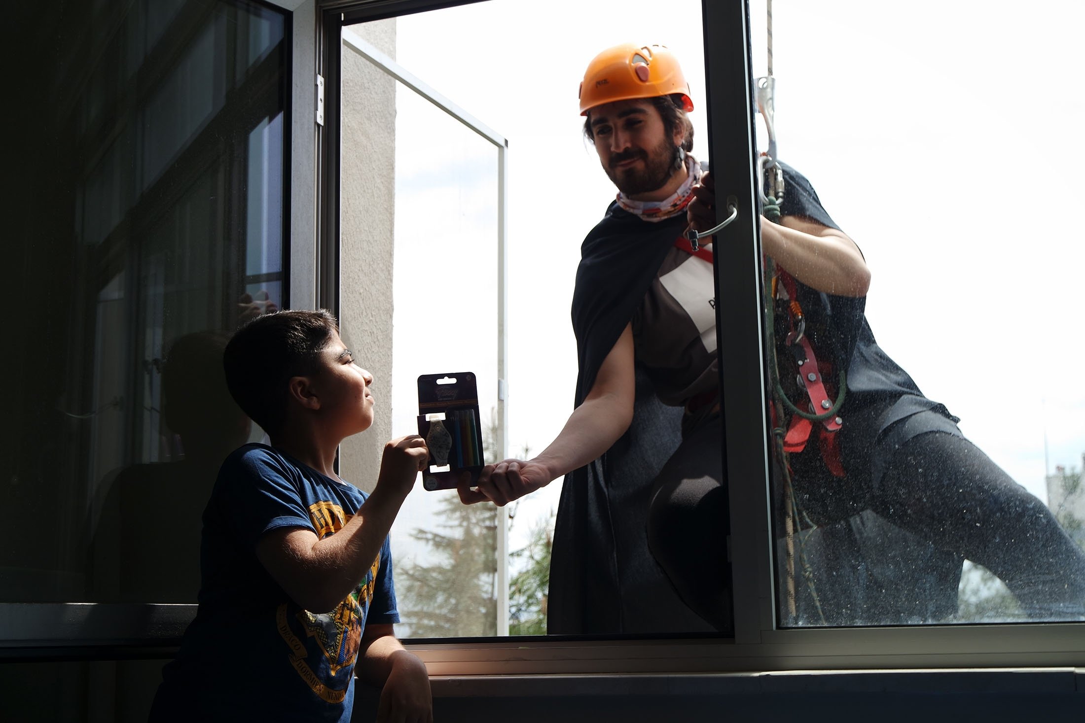 Bursa's superheroes rappel down to children's windows bearing gifts