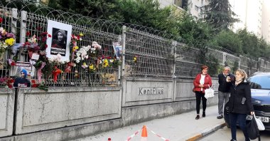People offer flowers and photos of Başak Cengiz at the spot she was murdered in Istanbul, Turkey, Nov. 15, 2021. (PHOTO BY MUSTAFA KAYA)